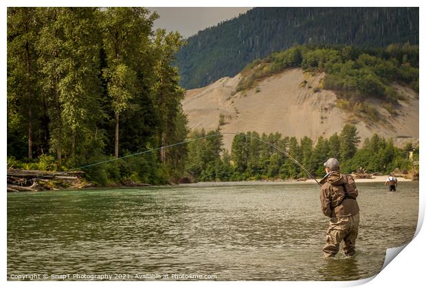 A fly fisherman hooked into a fish on a river with mountains and trees in the background Print by SnapT Photography