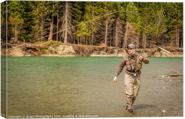 A sport fly fisherman hooked into a salmon on a river in British Columbia Canvas Print by SnapT Photography