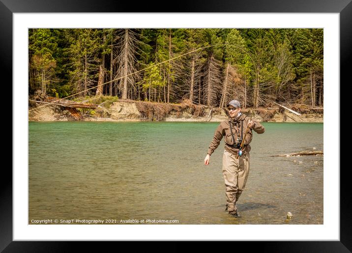 A sport fly fisherman hooked into a salmon on a river in British Columbia Framed Mounted Print by SnapT Photography