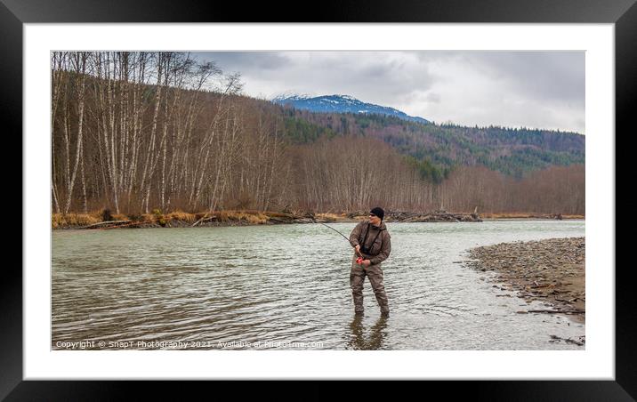 A fly fisherman hooked into a big fish in a river with the rod bent Framed Mounted Print by SnapT Photography