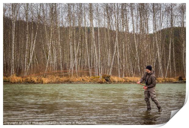 A fly fisherman hooked into a big fish in a river with the rod bent Print by SnapT Photography