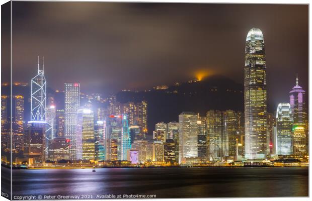 Tsim Shat Sui Victoria Harbour In Hong Kong At Night Canvas Print by Peter Greenway