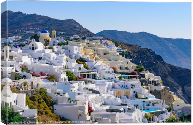 Traditional white buildings facing Aegean Sea in Oia, Santorini island, Greece Canvas Print by Chun Ju Wu