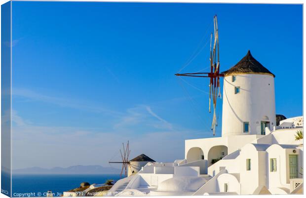 Windmill and traditional white buildings facing Aegean Sea in Oia, Santorini, Greece Canvas Print by Chun Ju Wu