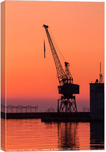 Port crane at sunset Canvas Print by Nic Croad