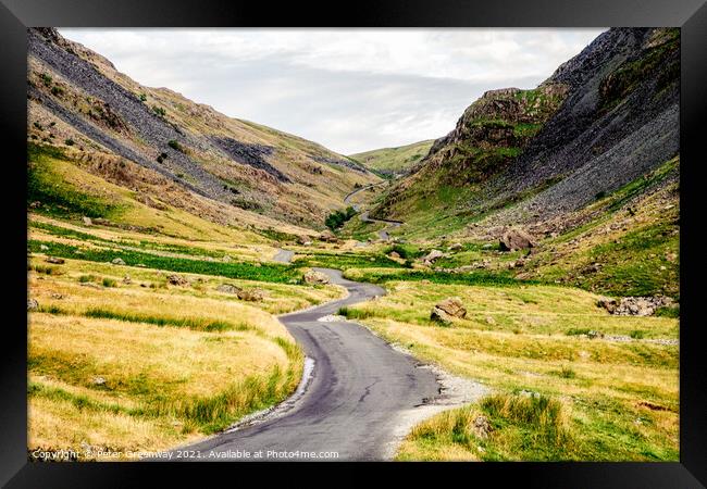The Winding Road Through The Honiston Pass In The Lake District Framed Print by Peter Greenway