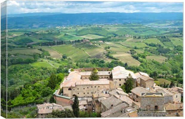 A view of Tuscany from a medieval tower in San Gimignano Canvas Print by Adrian Beese
