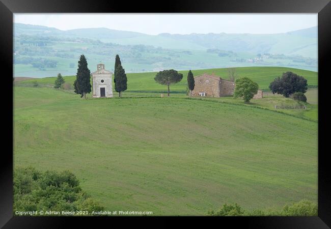 Hillside Farm and church in Tuscany Framed Print by Adrian Beese