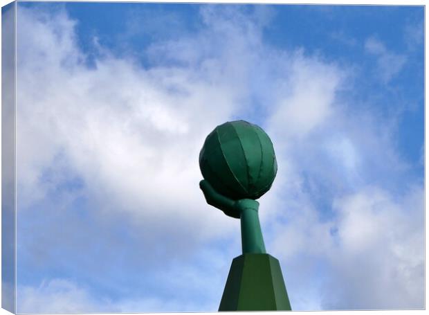 Green metal hand and ball Canvas Print by Roy Hinchliffe