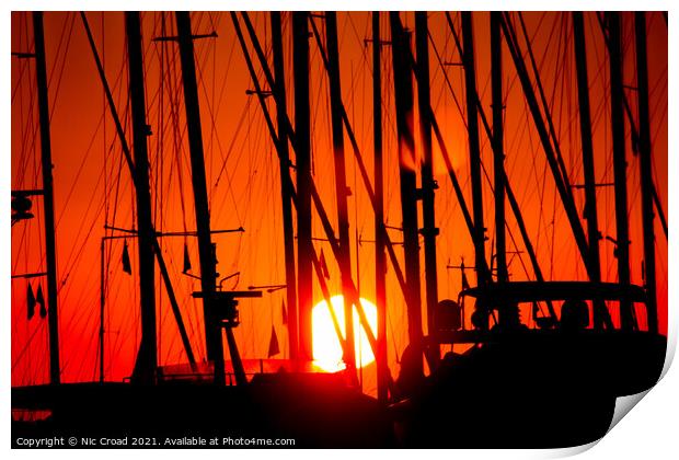 Sunset through silhouetted yacht masts Print by Nic Croad