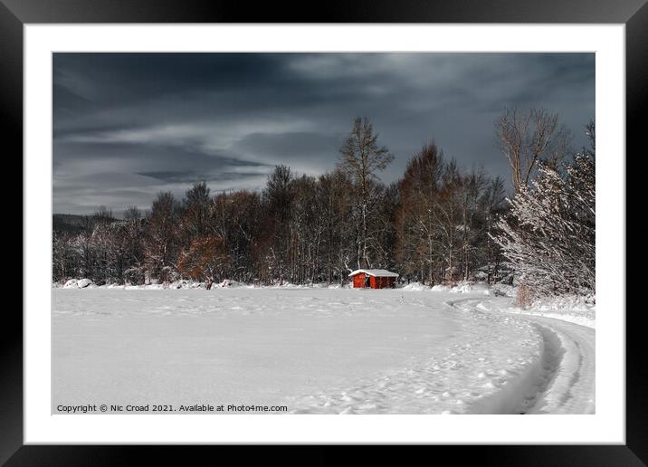 Winter scene with a single red barn Framed Mounted Print by Nic Croad