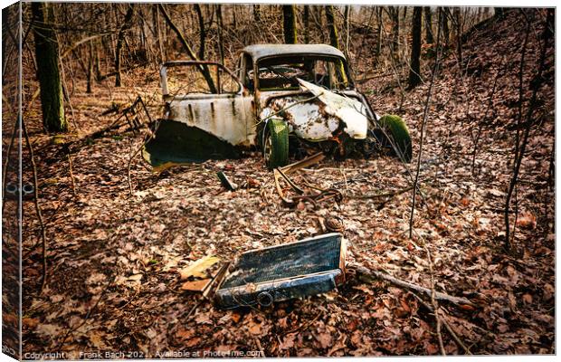Car wreck desolated worn and rusty left in a forest, Denmark Canvas Print by Frank Bach