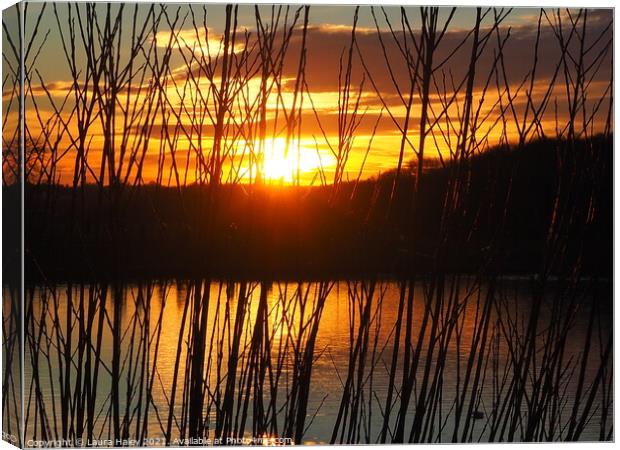 Sunset Over The Lake Canvas Print by Laura Haley