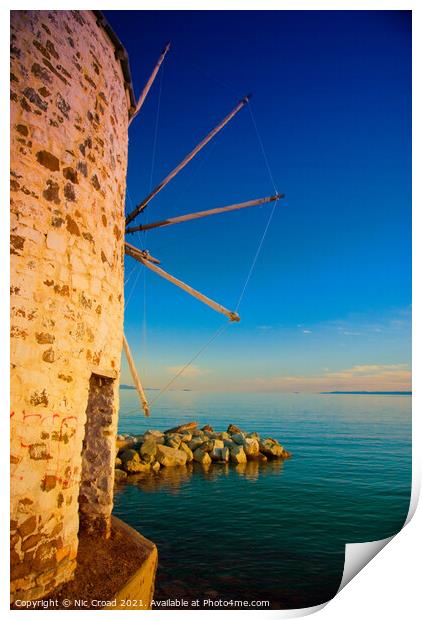 Greek windmill on the beach Print by Nic Croad