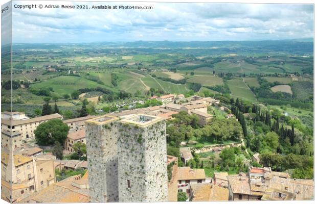 San Gimignano and the Tuscan countryside Canvas Print by Adrian Beese