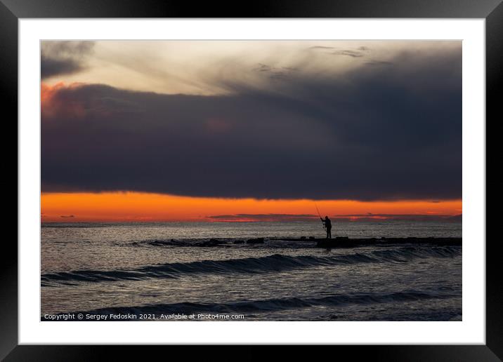Fisherman on the sea at sunset. Framed Mounted Print by Sergey Fedoskin