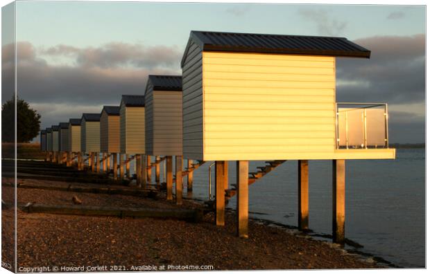 Osea Beach Huts towards dusk Canvas Print by Howard Corlett