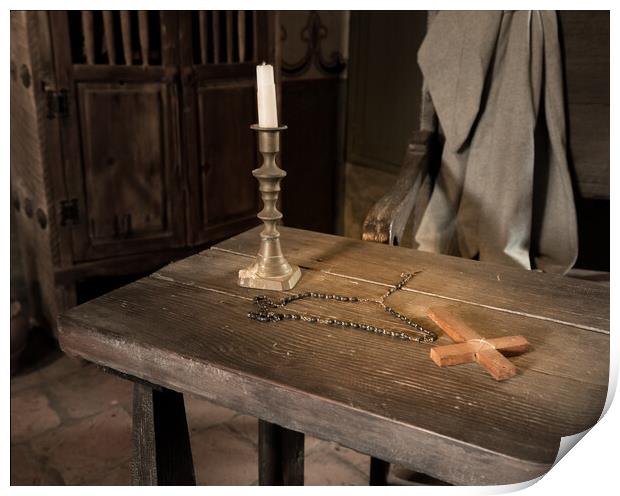 Ancient table with candle, rosary and cross in priest room Print by Steve Heap