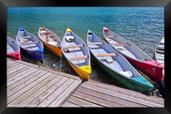 Colorful boats sitting near a wooden dock over some water Framed Print by PhotOvation-Akshay Thaker
