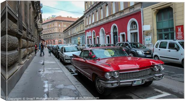 Vintage red cadillac deville car parked in a Budapest street in the evening Canvas Print by SnapT Photography