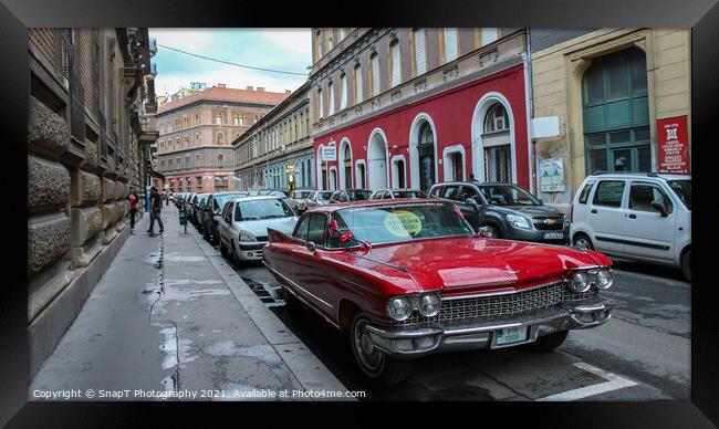 Vintage red cadillac deville car parked in a Budapest street in the evening Framed Print by SnapT Photography