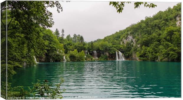 Water flowing over a series of waterfalls into a lake at Plitvice Lakes, Croatia Canvas Print by SnapT Photography