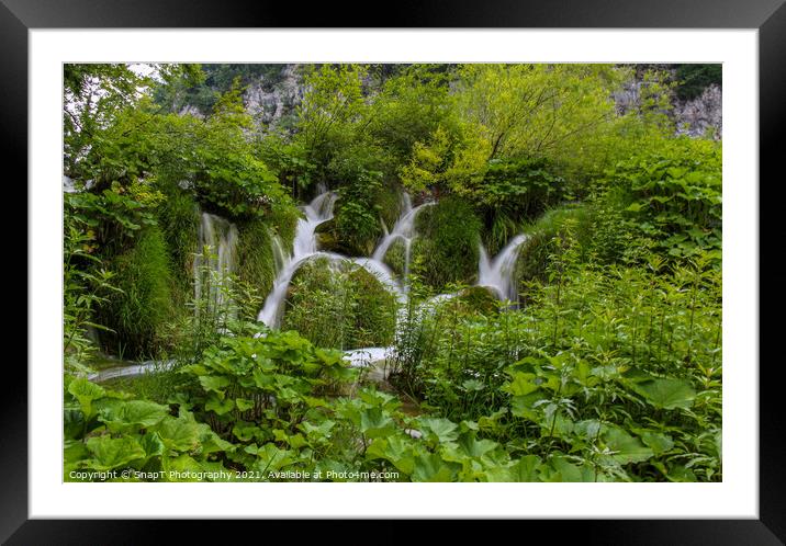 Water flowing through vegetation and over a waterfall at Plitvice Lakes Framed Mounted Print by SnapT Photography