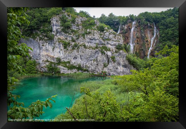 A large waterfall flowing over a mountain into a lake at Plitvice Lakes, Croatia Framed Print by SnapT Photography