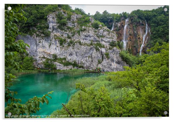 A large waterfall flowing over a mountain into a lake at Plitvice Lakes, Croatia Acrylic by SnapT Photography