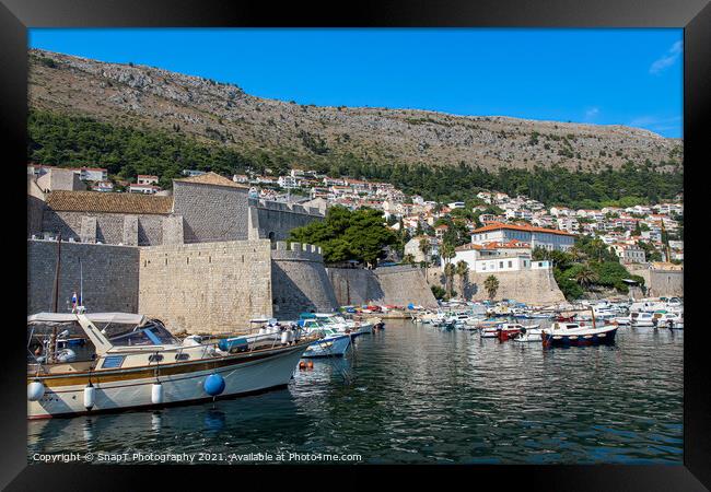 Boats moored in Dubrovnik Harbour by the city walls of the old town, Croatia Framed Print by SnapT Photography