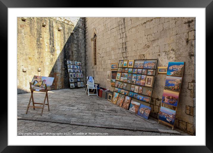 An artists stall in Dubrovnik's old town in a late summers afternoon, Croatia Framed Mounted Print by SnapT Photography