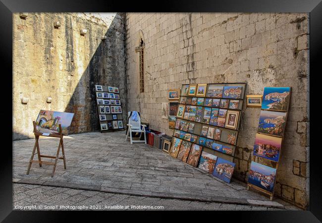 An artists stall in Dubrovnik's old town in a late summers afternoon, Croatia Framed Print by SnapT Photography