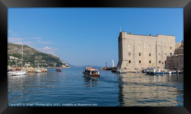 A boat leaving Dubrovnik harbour by the maritime museum in the old town, Croatia Framed Print by SnapT Photography