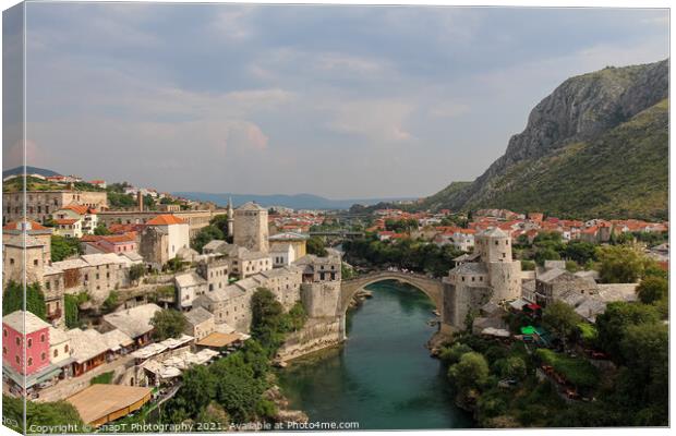A landscape view of the old town of Mostar, with the old bridge over the river Canvas Print by SnapT Photography