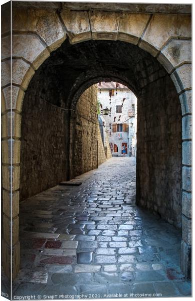 An alley way in the old town of Kotor, with flying brooms in the background Canvas Print by SnapT Photography