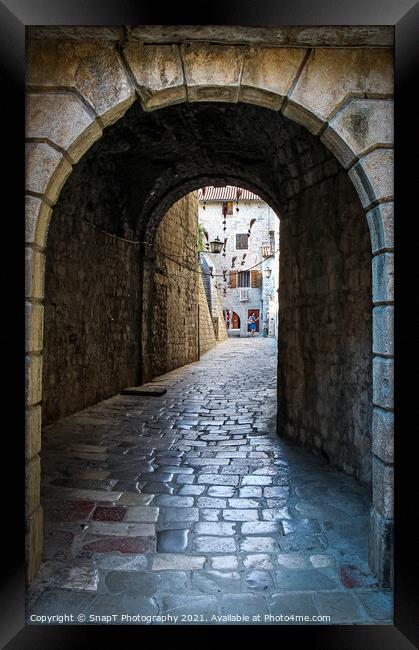 An alley way in the old town of Kotor, with flying brooms in the background Framed Print by SnapT Photography