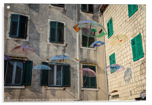 Flying umbrellas in a square in the old town of Kotor, in Montenegro Acrylic by SnapT Photography