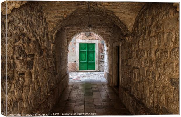 An alleyway in the old town of Kotor, Montenegro, with a green door at the end Canvas Print by SnapT Photography