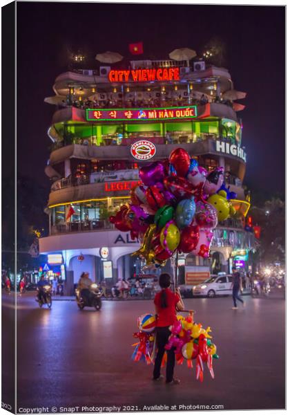 A lone balloon sellar at Dong Kinh Nghia Thuc Square, Hanoi, Vietnam. Canvas Print by SnapT Photography