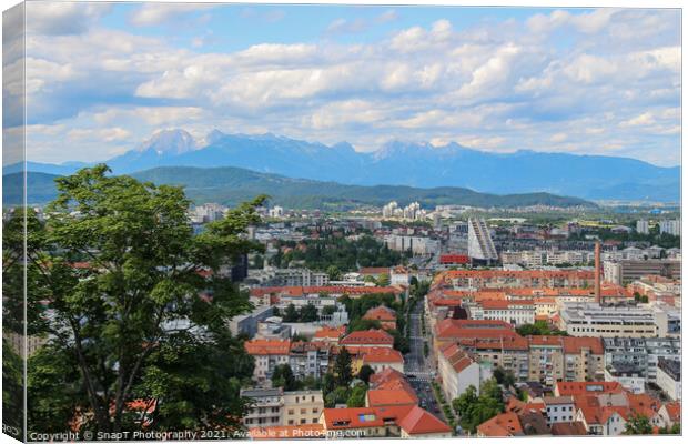 A view over Ljubljana to the mountains from the view point at Ljubljana Castle Canvas Print by SnapT Photography