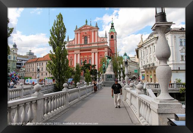 A view of the Franciscan Church across the Tromostovje or Triple Bridges Framed Print by SnapT Photography