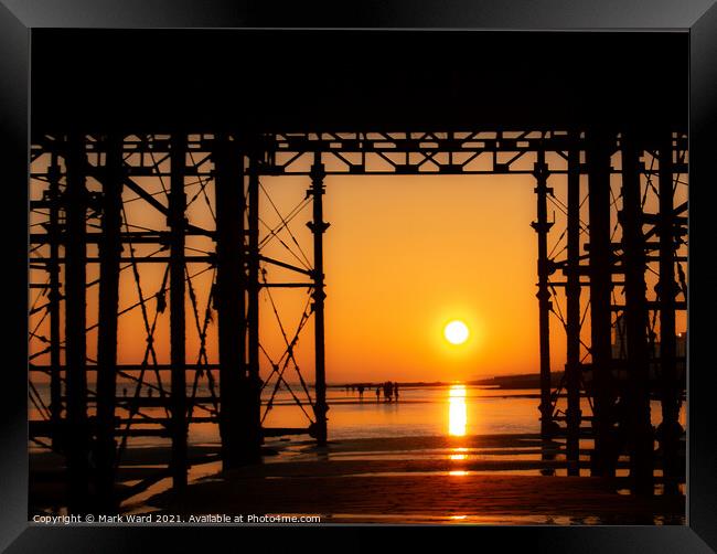 Appearing Through The Pier Framed Print by Mark Ward