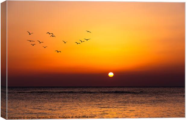 Bright sunset with a big yellow sun under the sea surface. Canvas Print by Sergey Fedoskin