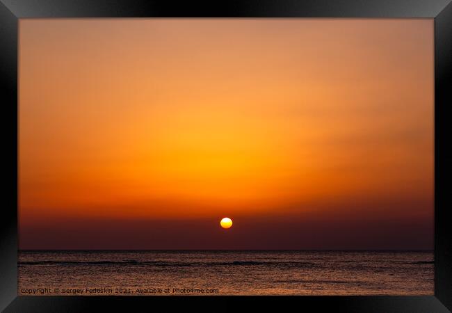 Bright sunset with a big yellow sun under the sea surface. Framed Print by Sergey Fedoskin