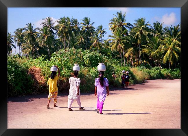 carrying water Framed Print by Hassan Najmy