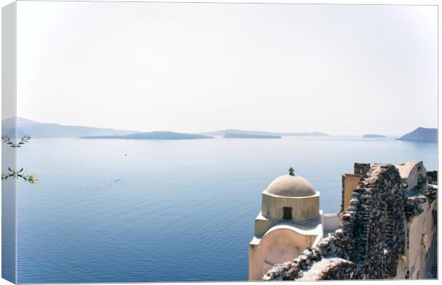 Santorini, Greece - September 11, 2017: Wide angle view of typical Church dome in Firostefani village and sea view with mountains in oia region against mediterranean sea. Canvas Print by Arpan Bhatia