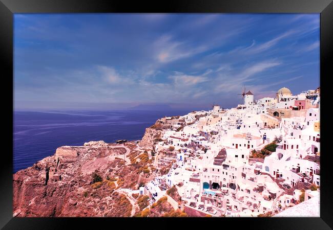 Santorini, Greece - September 11, 2017: Wide angle panoramic view of Oia Santorini white buildings on the hillside facing north against the blue sky. Cityscape of famous greek island Framed Print by Arpan Bhatia