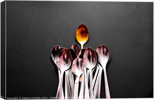 A luxury golden spoon stands out from the rest of the simpler an Canvas Print by Joaquin Corbalan