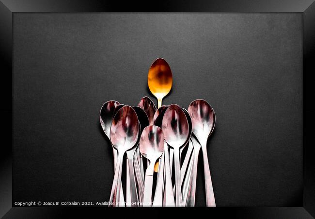 A luxury golden spoon stands out from the rest of the simpler an Framed Print by Joaquin Corbalan
