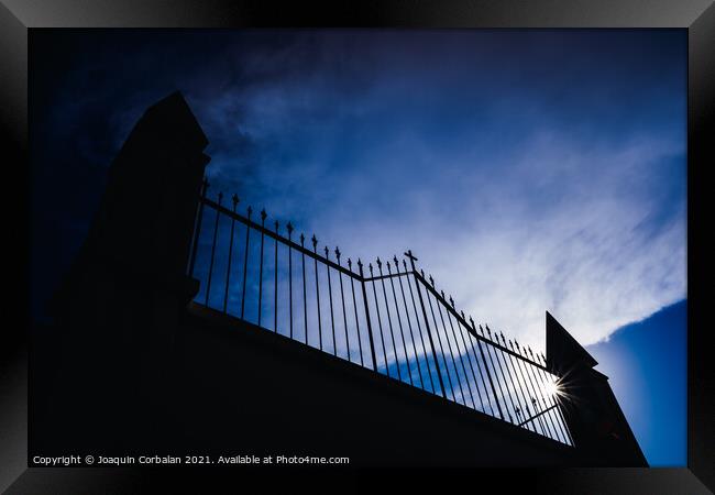 Metal grating of a cemetery with a cross on a white wall, copy s Framed Print by Joaquin Corbalan